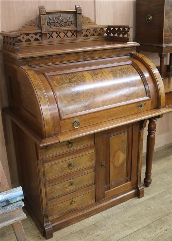 A late Victorian mahogany and walnut roll top desk, W.85cm